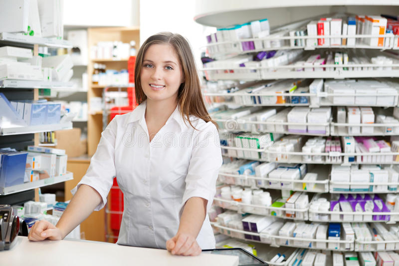 female-pharmacist-standing-counter-22419720